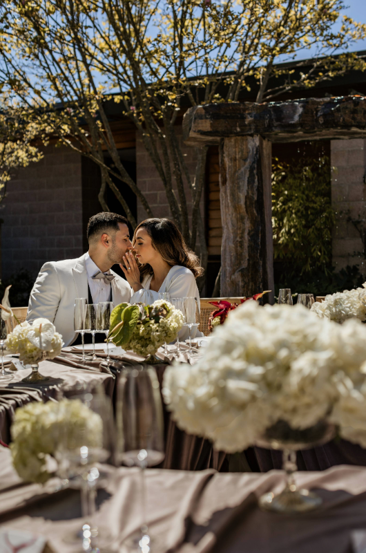 bardessono styled shoot couple kiss at table