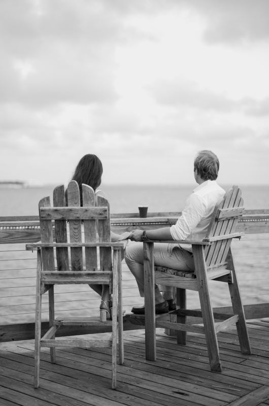 Morgan Abdalla and Travis Brown's North Carolina Engagement sitting by the water