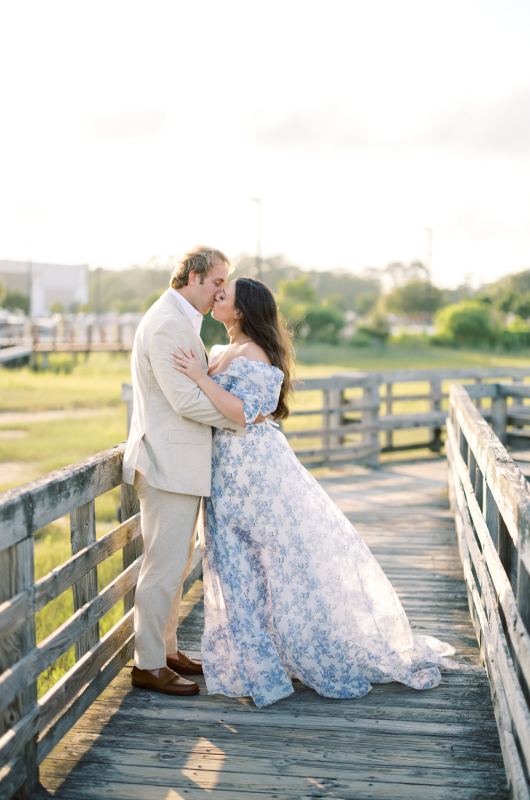 Morgan Abdalla and Travis Brown's North Carolina Engagement kiss on the boardwalk