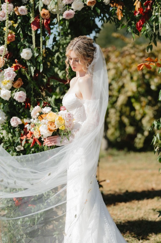Cask Room & Rose Vineyard Best Design Award Bride in front of flower arch