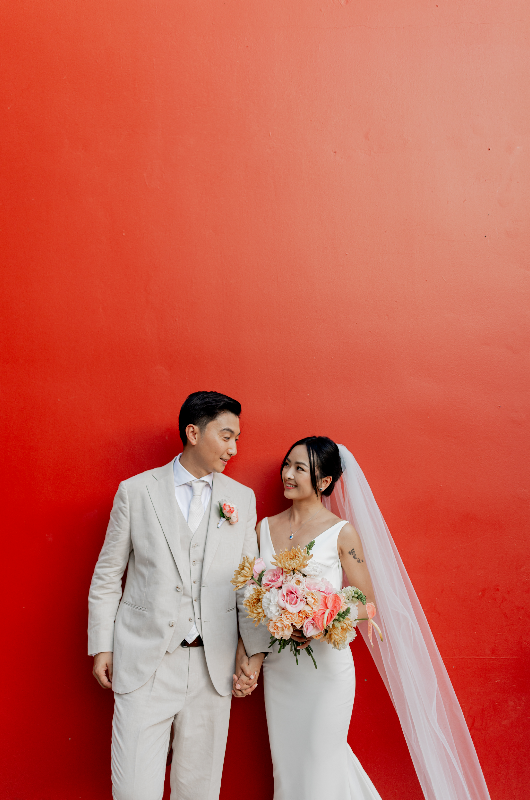 mango weddings maya riviera wedding example izzy and robert couple on red wall